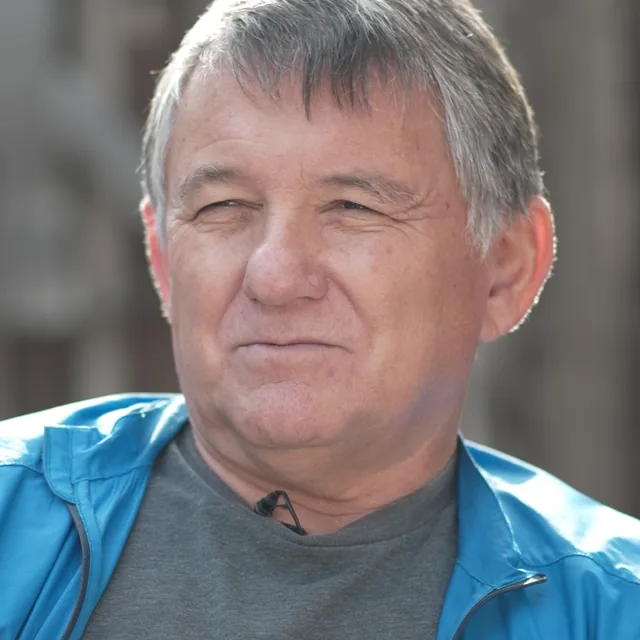 Jack Smith, grey-haired, in a blue jacket, smiling during his interview in Morro Bay.